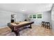 Bright game room featuring a pool table, neutral walls, and outdoor views at 3614 S Lois Ave, Tampa, FL 33629