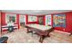 Spacious game room featuring a billiard table, unique artwork and access to other parts of the home at 3614 S Lois Ave, Tampa, FL 33629