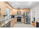 Well-lit kitchen showcases stainless steel appliances, granite countertops, and tile flooring at 3614 S Lois Ave, Tampa, FL 33629