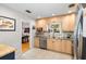 Cozy kitchen with light wood cabinets, stainless steel appliances, granite counters, and tile flooring at 3614 S Lois Ave, Tampa, FL 33629