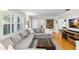 Well decorated living room with hardwood floors, large sofa, modern TV, and colorful rug at 3614 S Lois Ave, Tampa, FL 33629