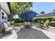 Inviting patio with comfortable seating under a large shade umbrella at 3614 S Lois Ave, Tampa, FL 33629