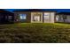 Night view of the rear exterior and backyard, with a covered patio at 5858 Shorebird Br, Land O Lakes, FL 34638