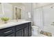Well-lit bathroom featuring a sleek vanity, shower-tub combination, and white tile flooring at 5858 Shorebird Br, Land O Lakes, FL 34638