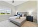 Bright bedroom with a tray on the bed, side tables and view of the neighborhood at 5858 Shorebird Br, Land O Lakes, FL 34638