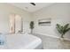 Light-filled bedroom featuring neutral walls, carpet, and a decorative painting at 5858 Shorebird Br, Land O Lakes, FL 34638