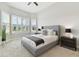 Bright bedroom featuring a large window with shutters and a ceiling fan at 5858 Shorebird Br, Land O Lakes, FL 34638