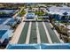 Overhead shot of Bocce ball courts with shelters and tennis courts in a well landscaped environment at 5858 Shorebird Br, Land O Lakes, FL 34638