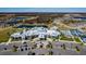 Aerial view of the expansive, light-filled clubhouse featuring ample parking and manicured landscaping at 5858 Shorebird Br, Land O Lakes, FL 34638