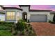 Charming single-Gathering home with a two-car garage, beautiful landscaping, and brick driveway at 5858 Shorebird Br, Land O Lakes, FL 34638