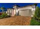 Inviting single-Gathering home with a brick driveway, two-car garage, and lush landscaping at 5858 Shorebird Br, Land O Lakes, FL 34638