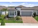 Beautiful home with a brick driveway, lush landscaping, and an inviting front entrance at 5858 Shorebird Br, Land O Lakes, FL 34638