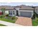 Attractive home with a brick driveway, well-maintained landscaping, and a two-car garage at 5858 Shorebird Br, Land O Lakes, FL 34638