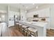 Bright and airy kitchen with stainless steel appliances and island with bar seating and white cabinetry at 5858 Shorebird Br, Land O Lakes, FL 34638