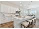 Modern kitchen featuring white cabinets, quartz countertops, and stainless steel appliances at 5858 Shorebird Br, Land O Lakes, FL 34638