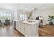 Bright, open kitchen with stainless steel appliances, island with quartz countertops, and stylish pendant lighting at 5858 Shorebird Br, Land O Lakes, FL 34638