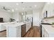 Well-lit kitchen featuring stainless appliances, white cabinets, a spacious island, and an open concept design at 5858 Shorebird Br, Land O Lakes, FL 34638