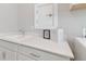 Close up of laundry room with white shaker cabinets, quartz countertops, sink, and laundry themed decor at 5858 Shorebird Br, Land O Lakes, FL 34638