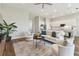 Open-concept living room with stylish decor, flowing seamlessly into the kitchen for easy entertaining and relaxing at 5858 Shorebird Br, Land O Lakes, FL 34638