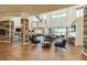 Spacious lounge area with high ceilings, modern furniture, and natural light at 5858 Shorebird Br, Land O Lakes, FL 34638