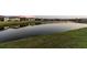 Scenic view of a pond reflecting homes in a residential community, enhancing the neighborhood's natural beauty at 5858 Shorebird Br, Land O Lakes, FL 34638