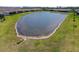 Overhead view of a pond surrounded by residential homes, offering a serene community setting at 5858 Shorebird Br, Land O Lakes, FL 34638