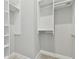 Bright and airy walk-in closet with shelving and hanging rods for optimal storage at 5858 Shorebird Br, Land O Lakes, FL 34638