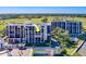 Beautiful aerial view of a condo building overlooking a lush green golf course and stunning landscaping at 6 Belleview Blvd # 505, Belleair, FL 33756