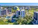 Scenic aerial view of a modern condo building surrounded by trees and meticulously manicured grounds at 6 Belleview Blvd # 505, Belleair, FL 33756