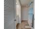 Bright bathroom featuring a shower with a blue shower curtain and white-painted wood paneling at 6 Belleview Blvd # 505, Belleair, FL 33756