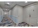 Hallway with patterned floors and neutral decor leads to the main entrance of unit 505 at 6 Belleview Blvd # 505, Belleair, FL 33756