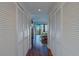 Hallway with white closet doors leading to bedroom with balcony and water views at 6 Belleview Blvd # 505, Belleair, FL 33756