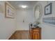 Inviting condo foyer featuring wood floors, elegant console table, and decorative mirror at 6 Belleview Blvd # 505, Belleair, FL 33756