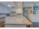Stylish condo kitchen with granite countertops and stainless steel dishwasher at 6 Belleview Blvd # 505, Belleair, FL 33756