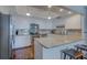 Contemporary kitchen featuring white cabinetry, granite countertops, and stainless steel appliances at 6 Belleview Blvd # 505, Belleair, FL 33756