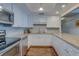 Updated kitchen featuring white cabinets, granite countertops, and modern appliances at 6 Belleview Blvd # 505, Belleair, FL 33756