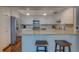 Bright condo kitchen with white cabinets, granite counters, and stainless appliances at 6 Belleview Blvd # 505, Belleair, FL 33756