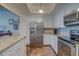 Bright kitchen featuring stainless steel refrigerator and sleek, white cabinetry at 6 Belleview Blvd # 505, Belleair, FL 33756