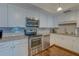Modern kitchen featuring white cabinets, stainless steel appliances, and granite countertops at 6 Belleview Blvd # 505, Belleair, FL 33756