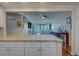Open-concept living space with breakfast bar overlooking the living room and balcony at 6 Belleview Blvd # 505, Belleair, FL 33756