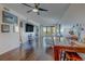 Spacious living room with hardwood floors, large windows, and a balcony view at 6 Belleview Blvd # 505, Belleair, FL 33756