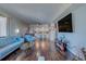 Open living space with hardwood floors, balcony access, and a view into the kitchen at 6 Belleview Blvd # 505, Belleair, FL 33756