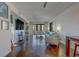 Well-lit living room with sliding glass doors leading to a balcony, surfboard, and hardwood floors at 6 Belleview Blvd # 505, Belleair, FL 33756