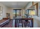 Cozy living room with a dark wood floor, leather sofa, and a balcony offering city views at 6 Belleview Blvd # 505, Belleair, FL 33756
