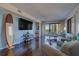 Comfortable living room with a large TV and access to a balcony with water views at 6 Belleview Blvd # 505, Belleair, FL 33756