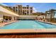 Large outdoor community pool with lounge chairs, lush landscaping, and a relaxing atmosphere at 6 Belleview Blvd # 505, Belleair, FL 33756