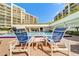 Inviting community pool with lounge chairs and tables, perfect for relaxing and enjoying the sunshine at 6 Belleview Blvd # 505, Belleair, FL 33756
