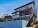 Exterior view of a multi-story home with blue siding, featuring an exterior staircase at 6241 Bayside Dr, New Port Richey, FL 34652