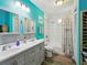 Bright bathroom featuring a double vanity, modern fixtures, and a shower-tub combo at 6241 Bayside Dr, New Port Richey, FL 34652