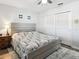Bedroom with neutral decor features a full bed, bedside table, and closet at 6241 Bayside Dr, New Port Richey, FL 34652